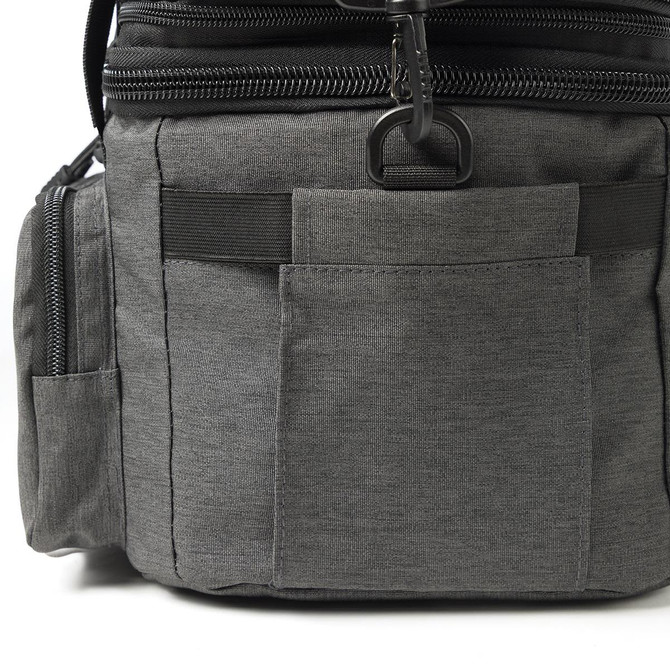 A grey expanding cooler with multiple pockets and zippers, featuring a sleek design and a black trim.