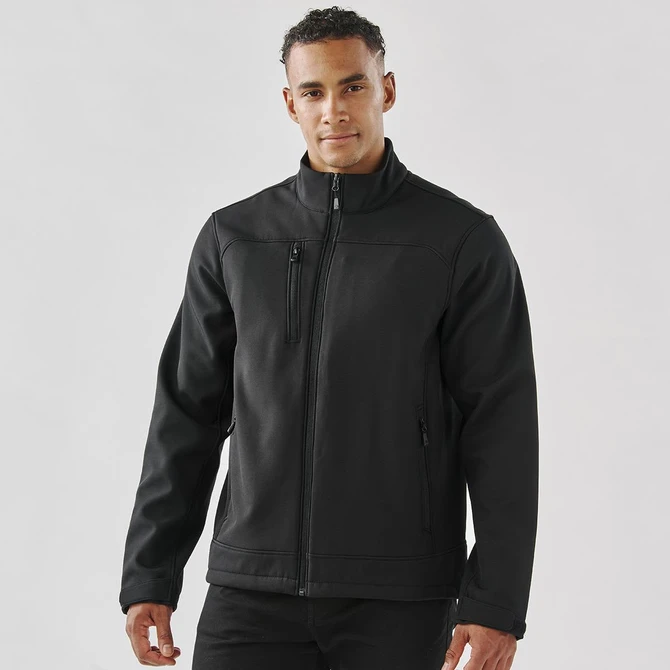 A black men's softshell jacket with a zip front, side pockets, and a chest pocket, featuring a logo.