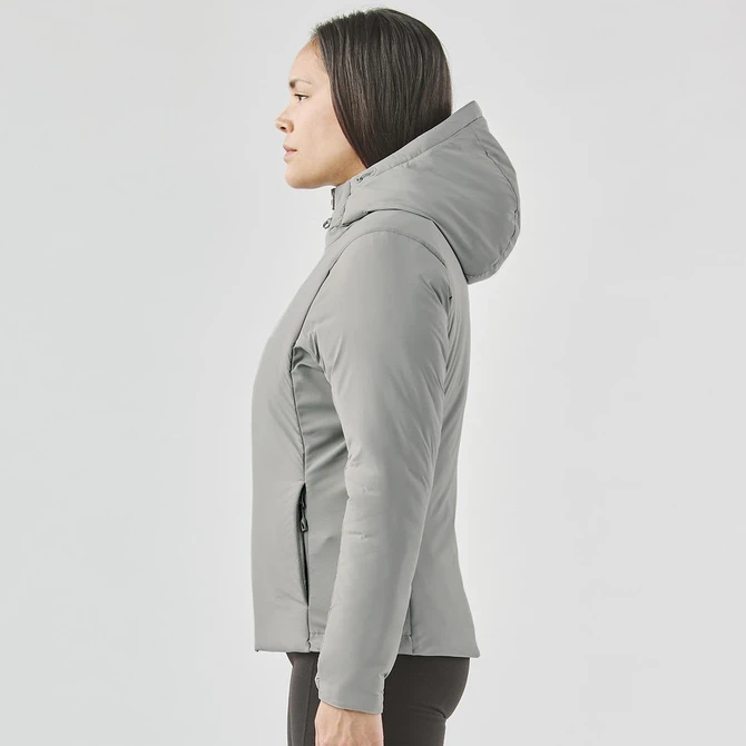 A women's puffer jacket in grey with a hood, featured from the side view. Includes a branding logo.