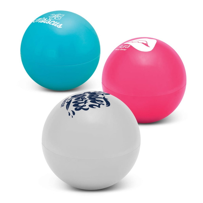 Three colorful lip balm balls in teal, pink, and white, each featuring different branding on their surfaces.
