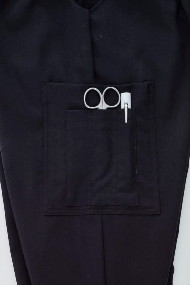 A pair of black cargo pants featuring a front pocket with scissors and a pen.