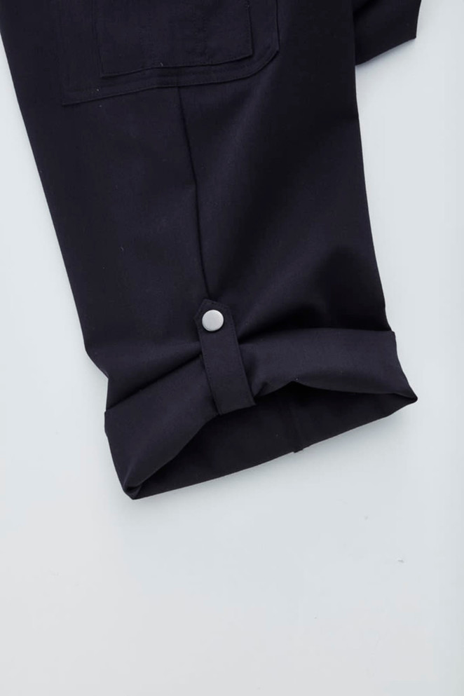 A pair of navy women's cargo pants featuring a rolled cuff and button detail.