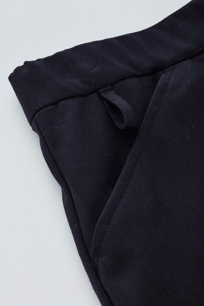 A close-up of a black women's comfort waist cargo skirt, highlighting the waistband and pocket details.