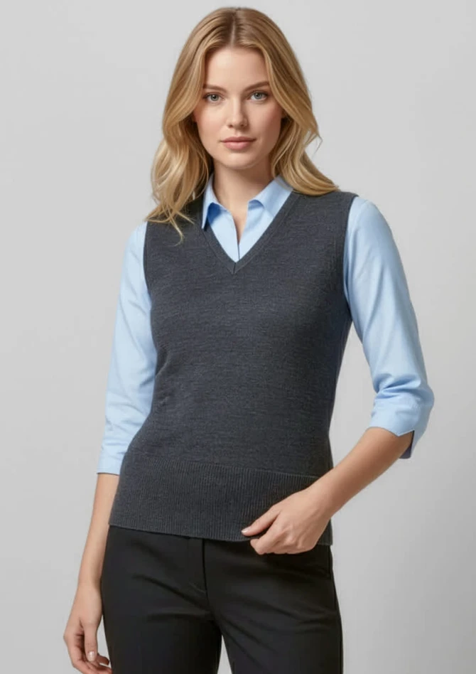 A grey women's vest with a v-neck design, worn over a light blue shirt and paired with black trousers.