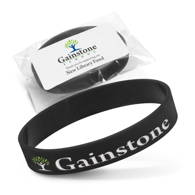 A black silicone wristband with debossed branding, presented in a clear package with a label.