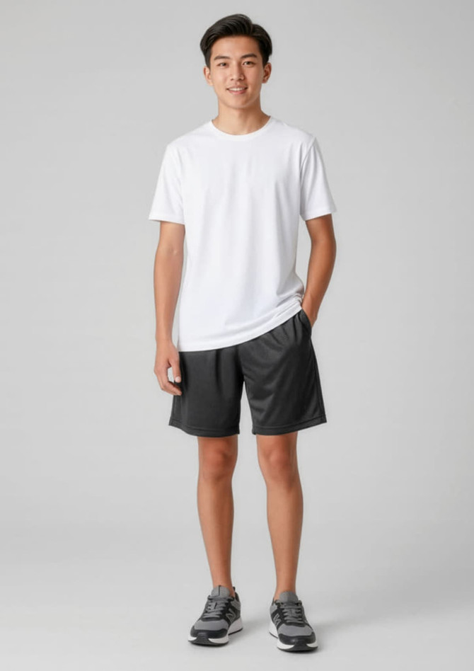 A model wearing black sports shorts and a white t-shirt, standing with hands in pockets. The shorts feature a logo.
