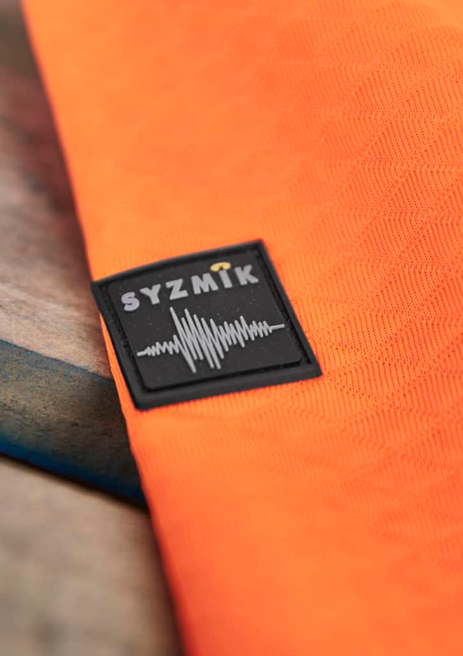An orange unisex hoodie with a textured jacquard design and a branded logo.