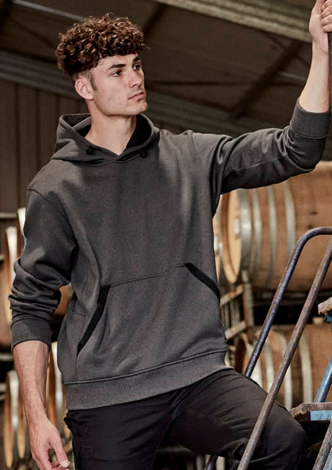 A unisex dark grey water-resistant hoodie with a front pocket and a hood, displayed in a work environment.