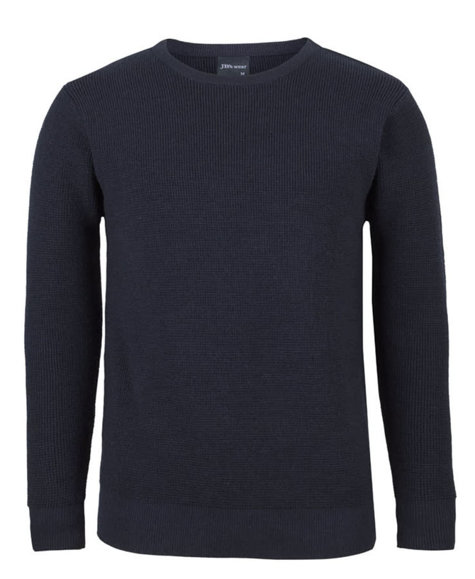 A navy blue knitted crew neck jumper with ribbed texture and long sleeves. It features a logo on the inner neck.