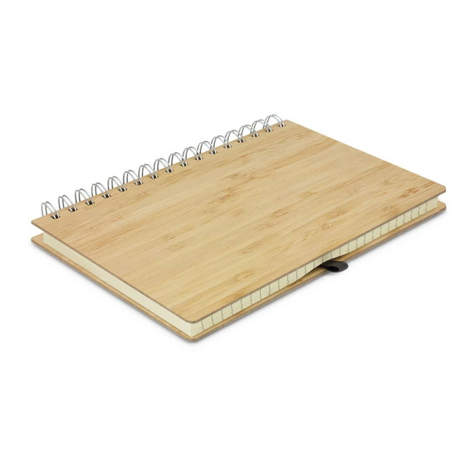 A bamboo notebook with a spiral binding and a leather strap, featuring a natural wooden finish.