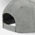 A grey cap with a textured fabric and an adjustable strap at the back. It features a logo.