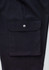 A pair of black cargo pants featuring a large side pocket with a snap closure and a smooth fabric finish.
