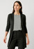 A longline cardigan in black, featuring a sleek design and open front. The model wears it over a striped top and black pants.