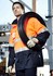 Men's hi-vis ultralite waterproof jacket in orange and navy, featuring reflective stripes and a logo. Model holds a coil of cable.