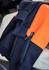 A textured jacquard hoodie featuring navy and orange colours, with a front zip pocket and a logo.