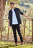 A long sleeve black button-up shirt worn over a white t-shirt, paired with black pants and boots, outdoors.