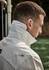 A long sleeve button-up shirt in white, featuring a high collar and casual fit. Includes a logo on the chest.