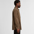 A button-up cord shirt in a warm brown colour, featuring a collar and button detailing, with a side view of a model.