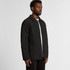 A black quilted puffer jacket with a button-up front, displayed on a model from the side.