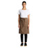 A woman wearing a brown canvas half apron over a white t-shirt and black pants, with a branding logo present.