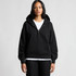 A black half-zip hoodie featuring a front pocket and a hood. It has a simple design and a relaxed fit.