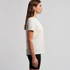 A light cream T-shirt is shown, featuring a crew neck and short sleeves, with a branding logo on it.