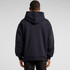 A dark navy hoodie with a large hood, featuring a relaxed fit and long sleeves. The back view showcases its simple design.