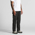Canvas cargo pants in black, featuring multiple pockets, worn by a person standing in a casual outfit.