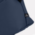 A navy soft-touch toiletry bag with a fabric tag featuring a logo.
