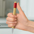A bamboo pen held in a hand, featuring a red accent on the grip and a silver tip.