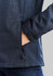 A soft shell jacket in navy with a geometric pattern and a zippered pocket. Features a snug cuff detail.
