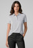 A women's short sleeve polo shirt in light grey, featuring a collar and a logo. Paired with black trousers.
