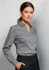A woman models a grey long sleeve button-up shirt, featuring a collar and a fitted design. The shirt has branding.