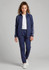 A model wearing navy track pants and a matching zip-up jacket, paired with a white top and white shoes.