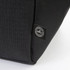 A black cooler bag featuring a logo, made from recycled materials. The textured fabric is visible in the image.