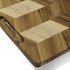 A chopping board featuring a geometric design with alternating light and dark wood tones and a curved edge.