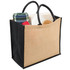 A jute tote bag with wide gusset, featuring black sides and a natural beige centre, filled with a blanket and other items.