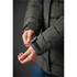 A close-up of a women's green parka jacket, showcasing the cuff detail and texture. The jacket has a logo.