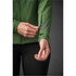 A green women's jacket featuring a zippered pocket on the sleeve and a fitted design. It has a logo on the fabric.