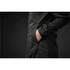 A black softshell jacket featuring a zippered front and side pockets, with a hand placed in one of the pockets.