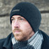 A Nebraska Cable Knit Beanie in black, featuring a subtle logo and a textured knit design.