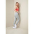 A model wearing light grey recycled unisex sweatpants and a pink crop top, posed against a muted background.