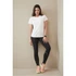 A white women's athletic t-shirt is worn with black leggings and sporty shoes, featuring a logo.