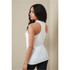 A woman wearing a white sleeveless tank top, featuring a sporty design and fitted silhouette. The top has a logo.