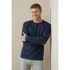A long sleeve men's shirt in navy blue, featuring a simple design and a logo on the chest.