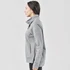 A grey women's cowl neck pullover jumper, featuring a high collar and side pockets, displayed on a model from the side.
