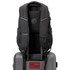 A black Swissdigital Stealth Neptune Backpack with padded straps and a logo, resting on top of a grey suitcase.