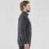 A men's fleece jacket in navy blue with a full zip and side pockets, featuring a subtle logo.
