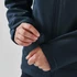 A dark blue softshell jacket with adjustable cuffs, featuring a person fastening the wrist strap.