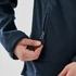 A navy women's softshell jacket featuring a zippered pocket. The jacket has a close-up view of the hand and zipper detail.